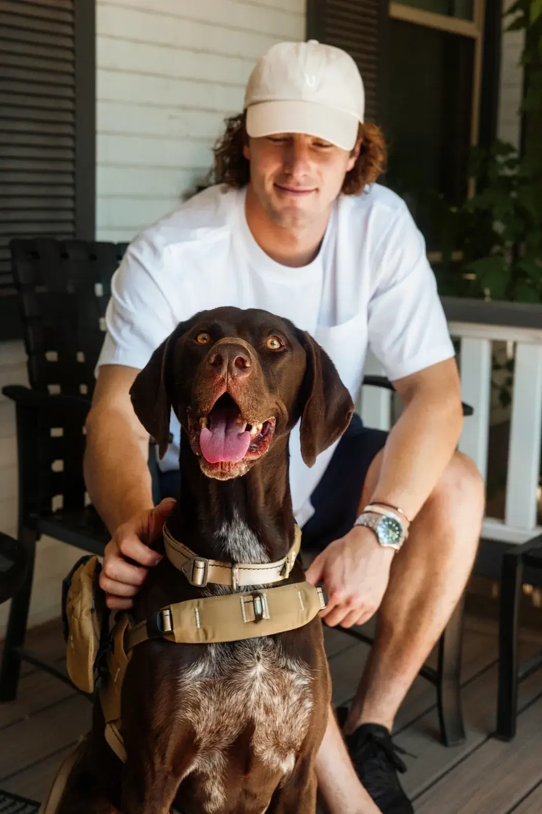 Man kneeling with a German shorthaired pointer wearing a Grove collar